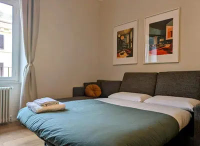 a bedroom with a bed with a blue blanket at Peaceful Roman Retreat in Rome