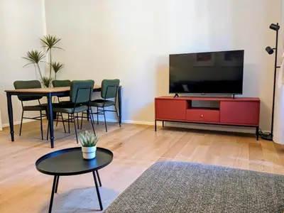 a living room with a tv and a red entertainment center at Peaceful Roman Retreat in Rome