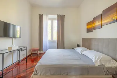 a bedroom with a large bed and a television at Attico vista San Pietro, vicino ai Musei Vaticani in Rome