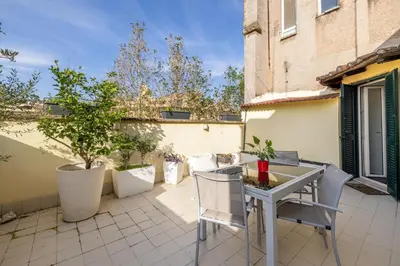 a patio with a table and chairs on a courtyard at Attico vista San Pietro, vicino ai Musei Vaticani in Rome