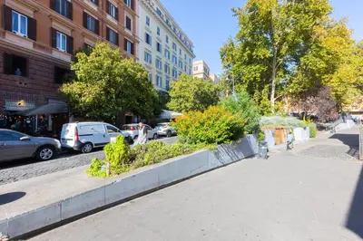 a city street with cars parked on the street at Khris Home Apartments - Trastevere - San Cosimato in Rome