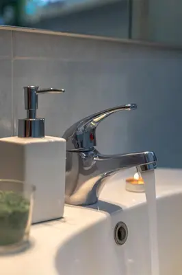 a sink with a faucet and a bottle of soap at Hope Home in Rome