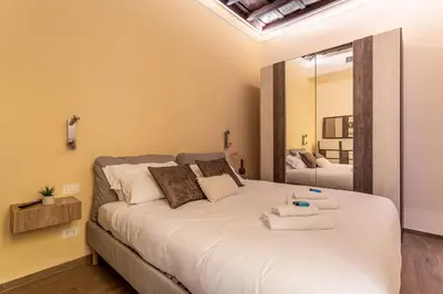 a bedroom with a large bed with towels on it at iFlat Augustus Suite near Pantheon in Rome