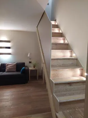 a staircase in a living room with a couch at La Dimora di Roma in Rome