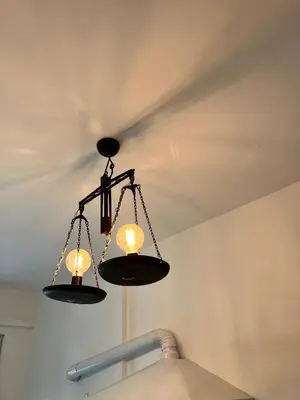 two lights hanging from a ceiling in a room at Ulisse home in Rome