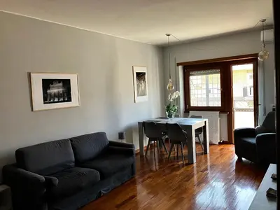 a living room with a couch and a table at Ulisse home in Rome