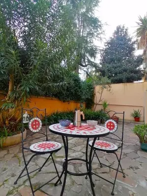 a table with two chairs and a tea kettle on it at Art House in Rome