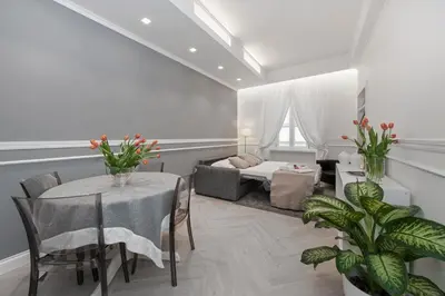a living room with a table and a bed at Trevi Apartment in Rome