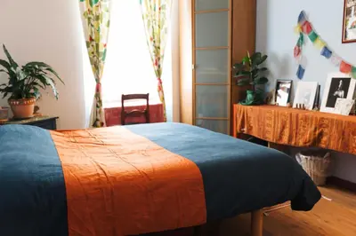 a bedroom with a bed with an orange and blue blanket at Lovely Sanctuary Central in Rome