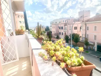 a balcony with potted plants and a view of a city at A&G central stay in Rome
