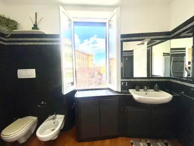 a bathroom with a sink and a toilet and a window at A&G central stay in Rome
