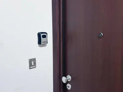 a wooden door with a cell phone on it at Appartamento Metro A e Vaticano Maroma in Rome