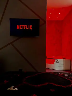 a bedroom with a netflix sign on the wall at Gold House Roma in Rome
