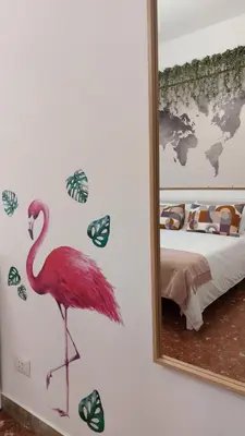 a flamingo sticker on a wall in front of a mirror at Way of Saying CASA in Rome