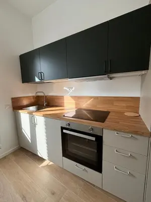 a kitchen with white and black cabinets and a sink at Maison Alteri in Rome
