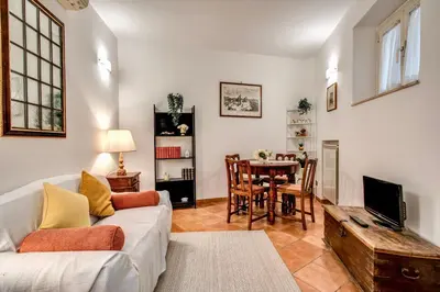a living room with a couch and a table at Charlotte Luxury Home Coronari in Rome
