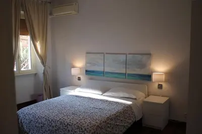 a bedroom with a bed and two paintings on the wall at La Casina delle Civette in Rome