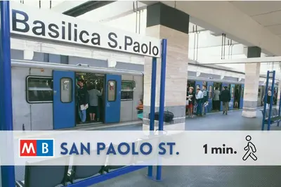 a train station with people waiting on a subway at San Paolo Suites Metro Station in Rome