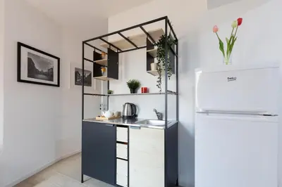a kitchen with a sink and a refrigerator at San Paolo Suites Metro Station in Rome