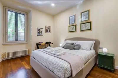 a bedroom with a large bed and a window at BDC - Purple Apt at San Giovanni in Rome