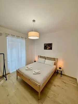 a bedroom with a large bed with white sheets at Pamphili Home - Un angolo di pace vicino Trastevere in Rome
