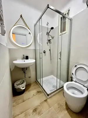 a bathroom with a shower and a toilet and a sink at Pamphili Home - Un angolo di pace vicino Trastevere in Rome