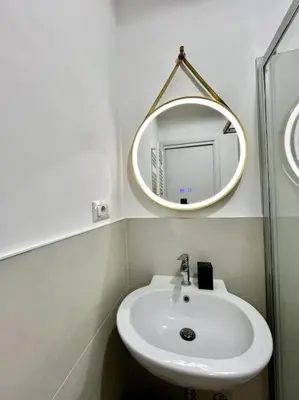 a bathroom with a white sink and a mirror at Pamphili Home - Un angolo di pace vicino Trastevere in Rome