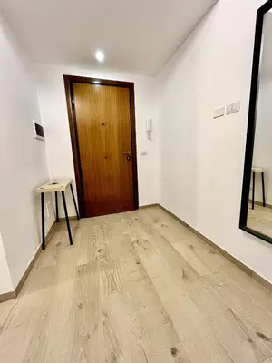 a room with a wooden door and a wooden floor at Pamphili Home - Un angolo di pace vicino Trastevere in Rome