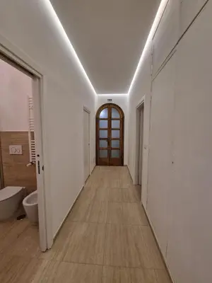 a hallway with a bathroom with a toilet and a door at VATICAN GUEST HOUSE ROOMS in Rome in Rome