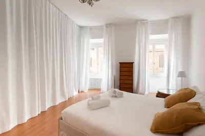 a bedroom with a large white bed with towels on it at Colosseum Number sixteen apartment in Rome