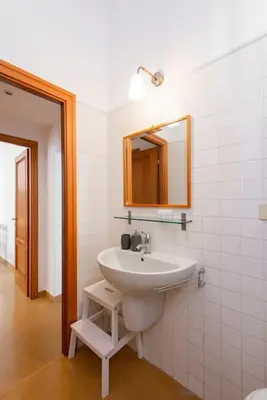 a bathroom with a sink and a mirror at Colosseum Number sixteen apartment in Rome