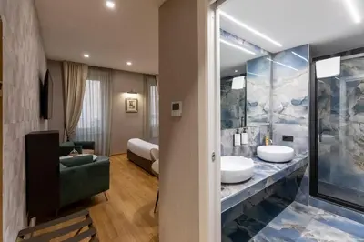a bedroom with a large bed with two pillows at Ara di Marte Home in Rome