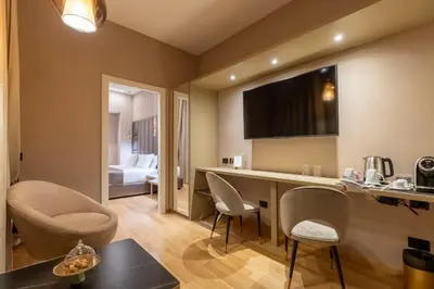 a room with a table and chairs and a bed at Ara di Marte Home in Rome