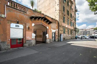 a building with a red door on a city street at Vatican Museums Cozy Apartment in Rome