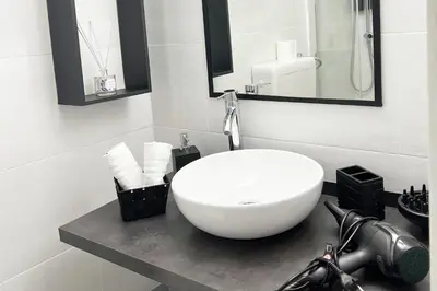 a bathroom with a white bowl sink on a counter at HOME Sweet Home Vatican City in Rome