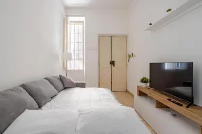 a living room with a couch and a flat screen tv at LA DOLCE VITA - stone's throw from the city center in Rome