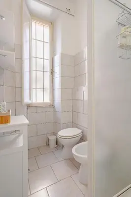 a white bathroom with a toilet and a shower at LA DOLCE VITA - stone's throw from the city center in Rome