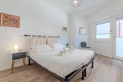 a bedroom with a large white bed with white sheets at Journalist Apartment Sistine Chapel in Rome