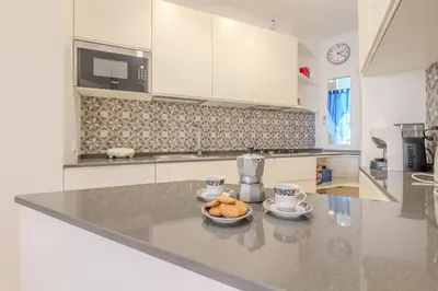 a kitchen with a counter with a bowl of food on it at Journalist Apartment Sistine Chapel in Rome