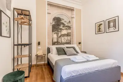a bedroom with a bed and a poster on the wall at Palazzo Sapienza Design Suites in Rome