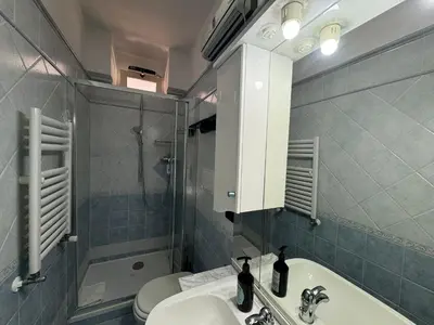 a bathroom with a sink and a shower and a toilet at Nice View in Ostiense with balcony in Rome