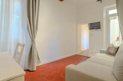 a living room with a couch and a tv at Cozy Flat Orso Navona square in Rome
