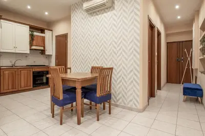 a kitchen with a wooden table and chairs at Borgo Vittorio 76 in Rome