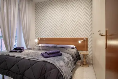 a bedroom with a bed with purple towels on it at Borgo Vittorio 76 in Rome
