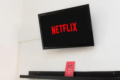 a television with the netflix sign on a wall at Centro Piccolo attico da sogno in Rome