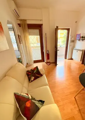 a patio with a wooden floor and rocks at Gecko, cozy flat at 5min from Metro and 10min from Colosseum in Rome