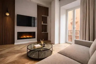 a living room with a couch and a fireplace at Vatican Boutique - 1 bedroom Apartment - Bilocale in Rome
