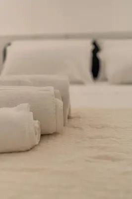 a row of white towels on a bed at Oasi artistica a Trastevere in Rome