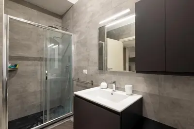a bathroom with a sink and a shower at Jmartins Vatican Apartment in Rome