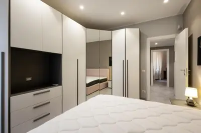 a bedroom with a large white bed and a television at Jmartins Vatican Apartment in Rome